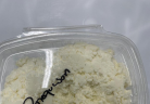 A clear plastic deli container of Clover Hill Dairy requeson