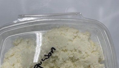 A clear plastic deli container of Clover Hill Dairy requeson